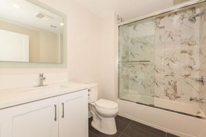 a white sink sitting next to a shower