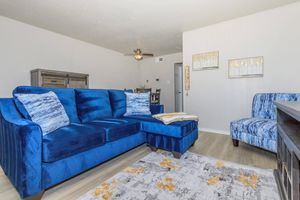 a bedroom with a bed and a couch in a living room