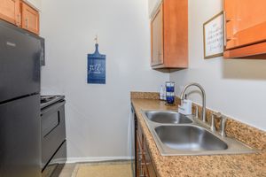 a kitchen with a sink and a refrigerator