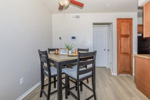 a kitchen with wooden cabinets and a dining room table