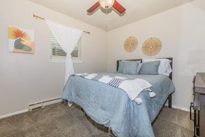 a bedroom with a bed and desk in a room