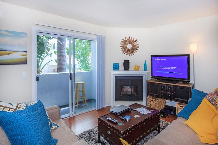 a living room filled with furniture and a flat screen tv