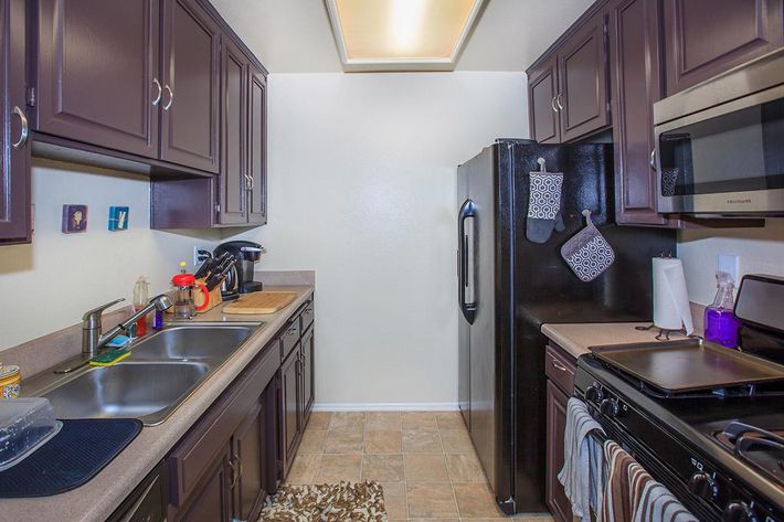 a kitchen with a stove a sink and a microwave