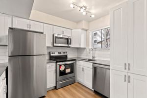 a kitchen with a stove and a refrigerator