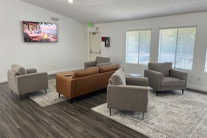 a living room filled with furniture and a flat screen tv