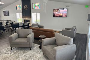 a living room filled with furniture and a fire place