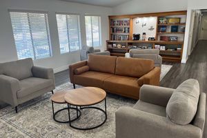 a living room filled with furniture and a flat screen tv