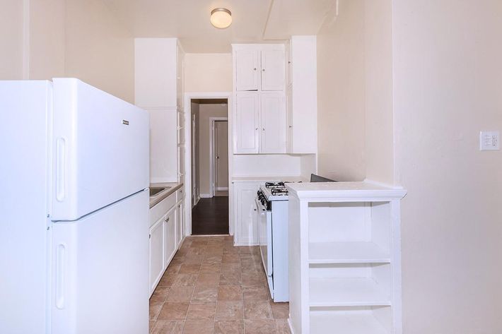 a white refrigerator freezer sitting inside of a kitchen