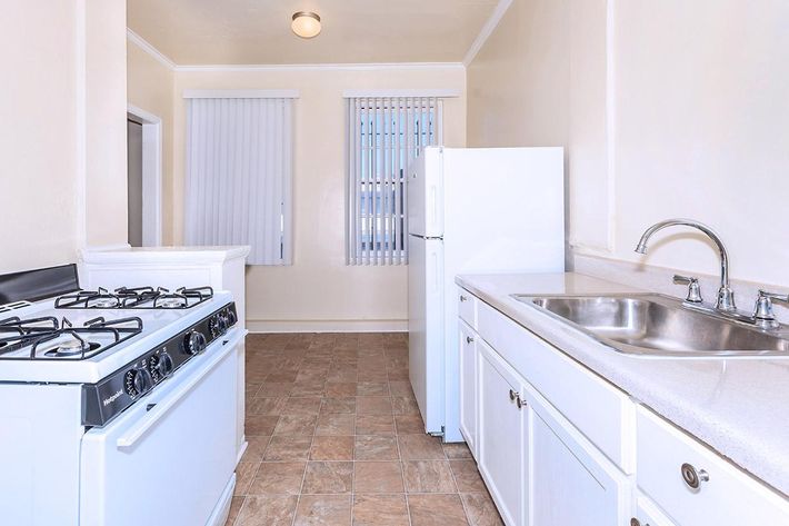 a kitchen with a white stove top oven