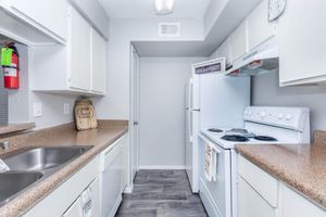 a kitchen with a sink and a mirror