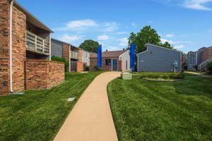 a large lawn in front of a brick building