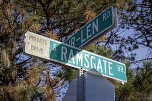 a close up of a street sign next to a tree