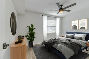 a bedroom with a bed and desk in a room