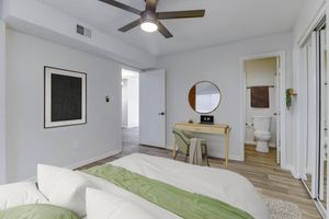 a living room filled with furniture and a bed in a bedroom