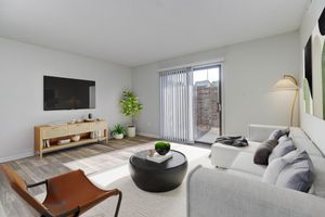 a living room filled with furniture and a large window