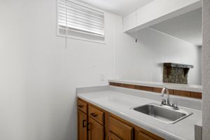 a kitchen with a sink and a mirror