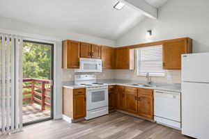 a large kitchen with stainless steel appliances and wooden cabinets