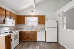 a kitchen with wooden cabinets