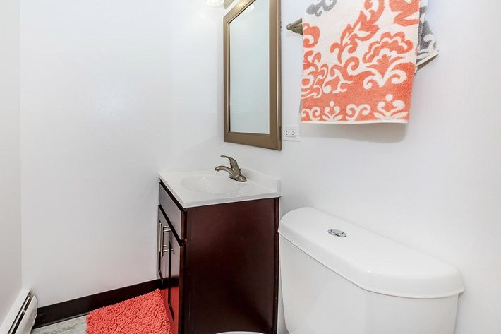 a white sink sitting under a mirror