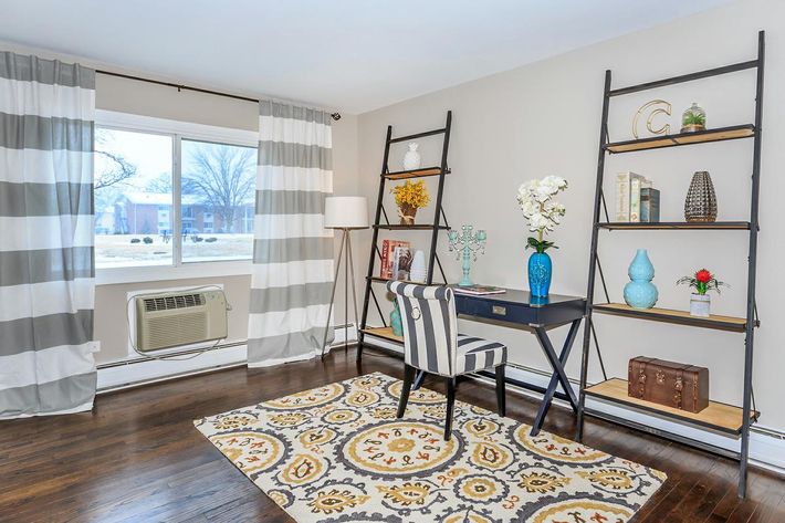 a living room filled with furniture and a large window