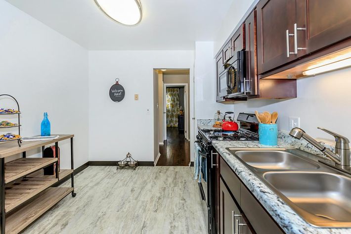 a kitchen with stainless steel appliances and wooden cabinets