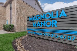 a blue sign in front of a brick building