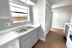 a kitchen with a sink and a window