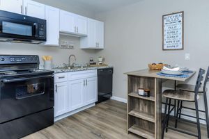 a stove top oven sitting inside of a kitchen