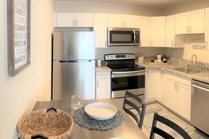 a stove top oven sitting inside of a kitchen