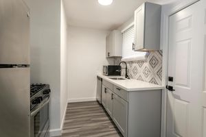 a kitchen with a sink and a refrigerator