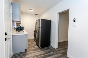 a kitchen with a sink and a refrigerator