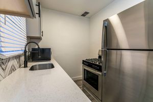 a kitchen with a sink and a mirror