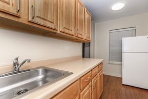 a kitchen with a stove a sink and a microwave