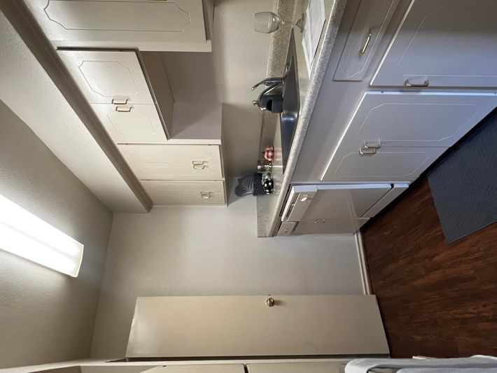 a kitchen with a stove sink and refrigerator