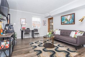 a living room filled with furniture and a tv