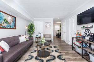 a living room filled with furniture and a flat screen tv