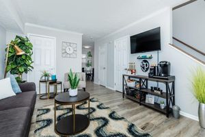 a living room filled with furniture and a window