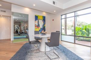 a living room filled with furniture and a large window