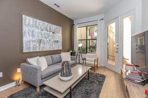 a living room filled with furniture and a large window