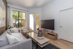 a living room filled with furniture and a flat screen tv