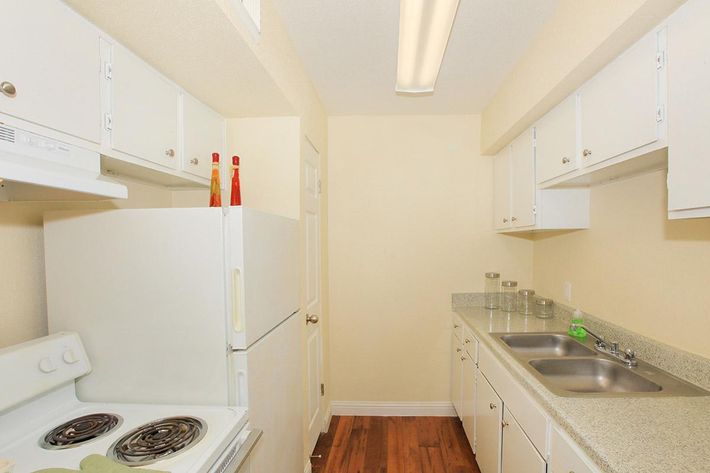 a kitchen with a sink and a refrigerator