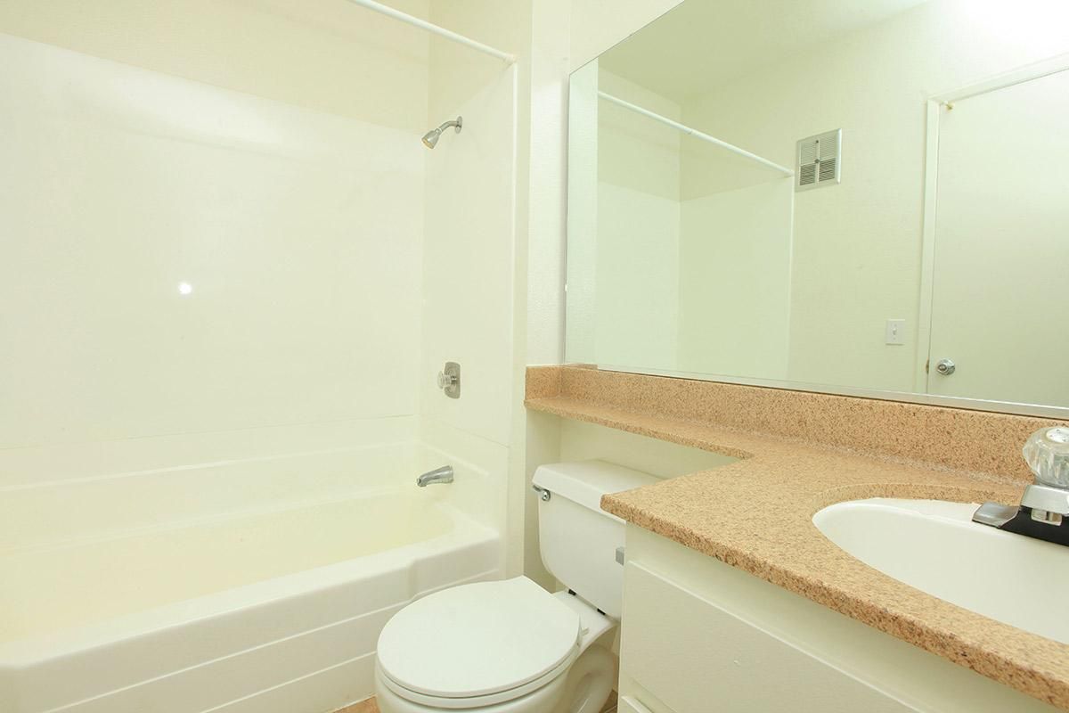 a white tub sitting next to a sink