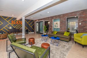 a room filled with furniture and a table in front of a building