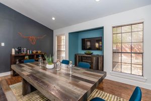 a living room filled with furniture and a large window