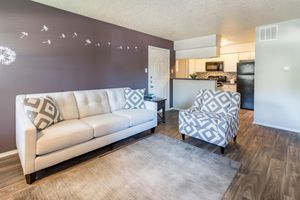 a living room filled with furniture and a bed