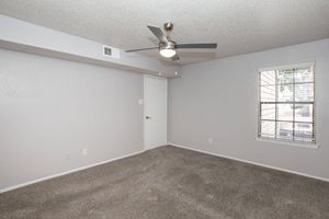 a large empty room with a sink and a mirror