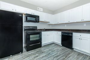 a stove top oven sitting inside of a kitchen