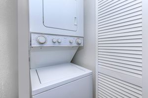 a white refrigerator freezer sitting next to a window