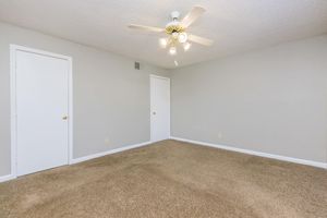 Bedroom with ceiling fan and carpeting