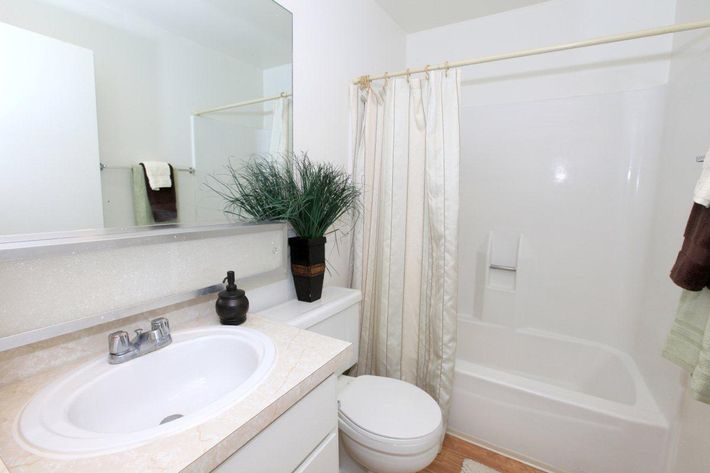 Furnished bathroom with a white shower curtain